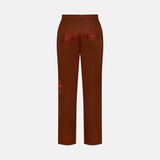 Coffee Sweatpants, back view, with red studded design across the back and a red logo on the left leg